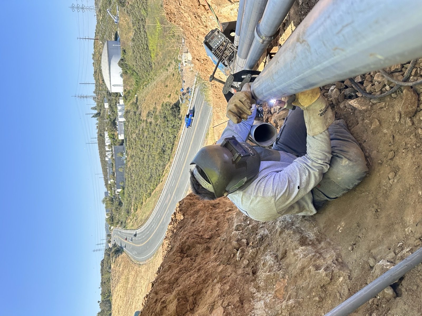 Welder in trench